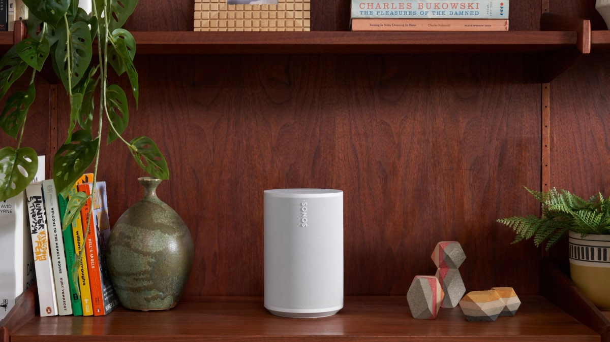 Sonos Era 100 Smart Speaker in white on a shelf.